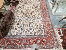 Eastern style cream ground carpet with central floral pattern with multiple herati and floral