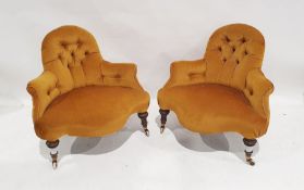 Pair of early Victorian wide-seated low armchairs, yellow upholstered with serpentine front rail, on