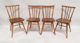Set of four Ercol elm seated stick back chairs together with a pair of Ercol stained stick back