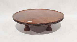 19th century mahogany lazy susan, the circular dished top with reeded edge, on circular base of four