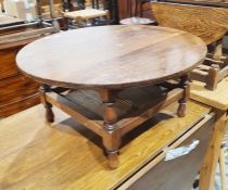 Oak circular coffee table with turned and block supports, galleried undertier, 36cm x 74.5cm