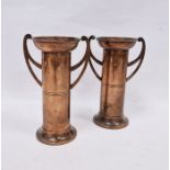 Pair of Arts and Crafts copper two handled vases, each cylindrical with flared rim, stamped 'British