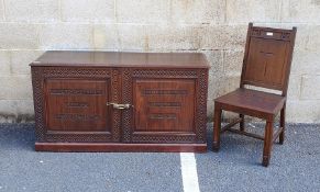 Oak chair with cross to the back, moulded legs and a stained cupboard with carved decoration, 'Whoso