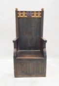 20th century oak ecclesiastical box chair, with decorated top rail, and lift-up seat with linen fold