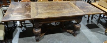20th century oak dining table in the Jacobean taste, the rectangular top with draw leaves, on cup
