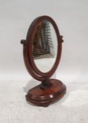 19th century dressing table mirror, the oval mirror in moulded frame, on shaped platform base