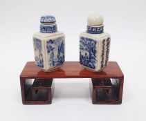Two Chinese snuff bottles with wooden stand
