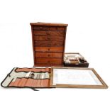 Miniature microscope in box, rolled case of possibly bookbinder's tools, collector's cabinet