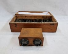 A stereoscope with approximately forty-six glass slides depicting various WW1 trench and wartime