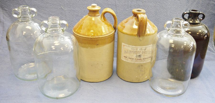 Two stoneware flagons, one with label for 'R J Stokes & Co Ltd, Sheffield', four glass demijohns and