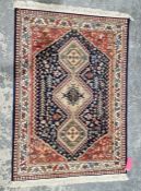 Modern French Senneh style blue ground rug with three central lozenge medallions surrounded by