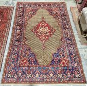 North East Persian Moud red ground carpet with large central floral medallion enclosed by