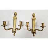 Pair of gilt two-branch wall sconces with pineapple finials, 29cm (2)