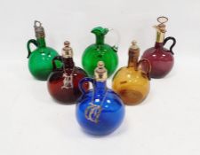 Five coloured glass bottles with metal mounts, 19th century, with white/gilt metal collar and