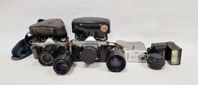 Collection of vintage cameras, accessories and camera bags including a Canon AE1 program camera with