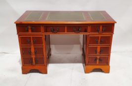 Reproduction yew wood pedestal desk with tooled green leather top above a frieze drawer flanked by