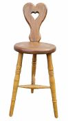 Arts & Crafts oak and stained wood spinning chair having pierced heart-shaped back, circular seat,