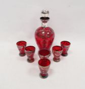 Ruby tinted silvered spirit decanter and stopper, 22cm high and six shot glasses, early 20th