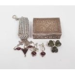 Silver four-leaf clover brooch, a silver and garnet-coloured necklace with matching earrings, a