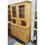 Modern beech dresser with two glazed cupboards over two central short drawers on rectangular base