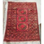 Eastern style red ground rug with three elephant foot guls to multiple geometric borders, 180cm X