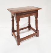 Oak joint stool with moulded edge and incised moulded frieze raised on angled turned legs with