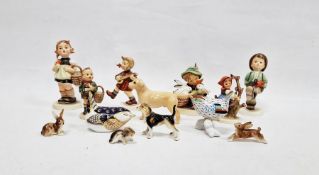 Group of Hummel figures of children at various pursuits, one little girl climbing a tree, Beswick