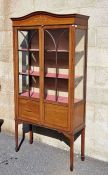 Edwardian Sheraton-style mahogany display cabinet with curved pediment painted with scrolls and
