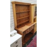 Pine dresser with ogee moulded cornice above three shelves, on rectangular moulded base above two
