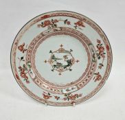 Chinese export plate, 18th century, painted with a central landscape and shrubs, within iron-red and