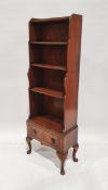 Early 20th century mahogany waterfall open front bookcase with three shelves over single drawer,