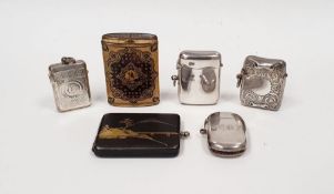 Japanese Komai cigarette case decorated with mountain and bridge, four silver vesta cases and a