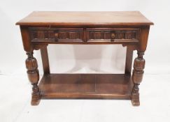 20th century carved stained oak side table in the Elizabethan-style, with two frieze drawers