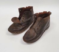 Old pair of child's leather and wooden-soled clogs
