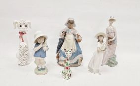 Two Lladro figures of girls,  comprising a girl carrying a basket with kittens at her feet, enriched