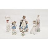 Two Lladro figures of girls,  comprising a girl carrying a basket with kittens at her feet, enriched