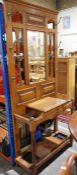 20th century oak hallstand with central bevelled mirror flanked by eight hooksCondition ReportThe