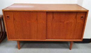 20th century teak sideboard with two sliding doors above tapering stump feet H 73cm X W 122cm X D