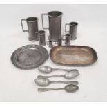 Pewter items to include a graduated set seven measure mugs, four spoons, plate and white metal dish
