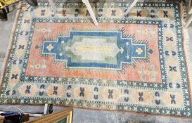 Large Turkish orange ground wool pile rug with large centralised geometric medallion surrounded by