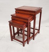 Nest of three modern Chinese rosewood occasional tables of rectangular form, on square section