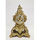 French mantel clock in a gilt metal rococo style body, Roman enamel numerals to the dial, the glazed