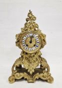 French mantel clock in a gilt metal rococo style body, Roman enamel numerals to the dial, the glazed