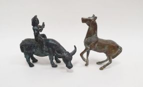 Metal model of a figure riding an ox together with a metal model of a horse (2)