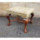 Carved walnut footstool in the early Georgian-style with rectangular tapestry top decorated with