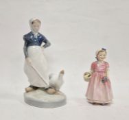 Royal Copenhagen figure of girl attending a goose, with blue wave marks, pattern no.528, on oval