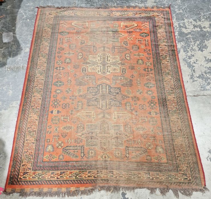 Large Eastern style red ground rug with four geometric medallions enclosed by stylised geometric