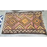 South West Persian Qashgai brown ground kilim with two stepped lozenge medallions enclosed by two