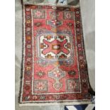 Modern Eastern style cream ground rug with one row of seven elephant foot guls to multiple geometric