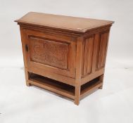 Oak side cabinet, the chamfered sides with linenfold panelling, foliate scroll carved panel to the